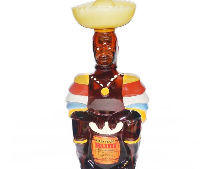 Old Oak Rum empty Limbo Drummer bottle. Original yellow plastic Sombrero lid and labels. Made by Angostura in Trinidad.