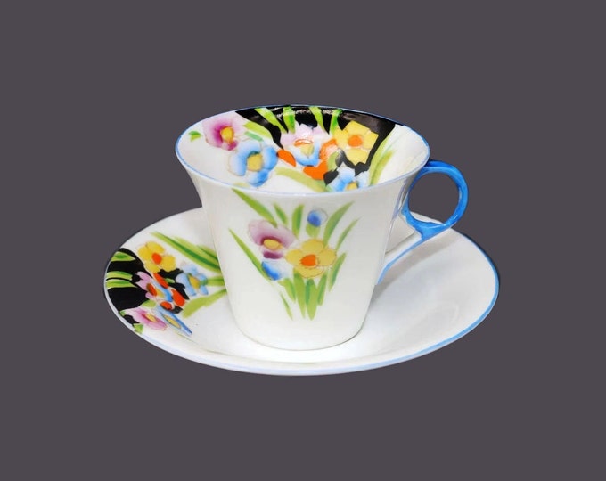 Hand-painted Nippon floral cup and saucer set. Multicolor flowers, white ground, blue handle and trim.