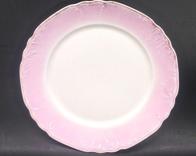 Victorian-era Wedgwood Royal Semi Porcelain luncheon or dinner plate. Pink rim, white center, embossed scrolls. Flaw (see below).