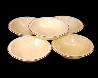 Five Poole Pottery Parkstone rimmed stoneware fruit nappies, dessert bowls made in England.