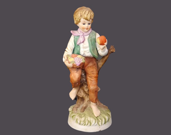 Giftcraft porcelain bisque figurine. Young boy holding fruit. Made in Japanese Taiwan. Minor flaw (see below).
