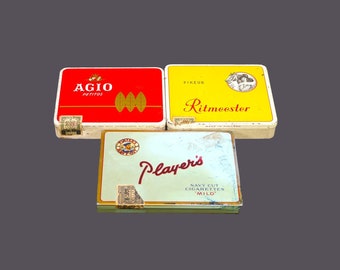 Three cigarette | cigar tins. Agio Petitos, Ritmeester, Player's Navy Cut. Original duty seals, hinged lids.