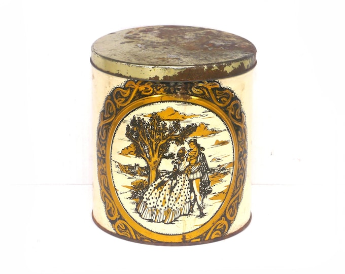 Biscuit tin for use as tea caddy or canister. Lithographed romance scene, detailed scrollwork. Attributed 1930s England.