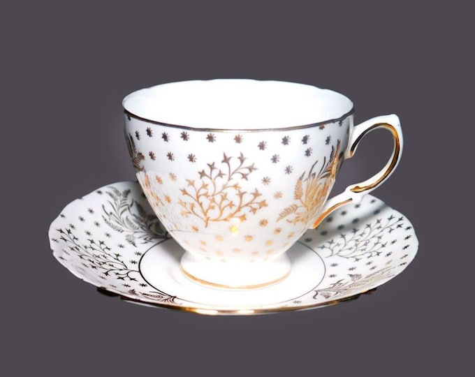 Royal Malvern 7645 cup and saucer set. Bone china made in England. Hand-decorated golden leaves, ferns and stars on white.