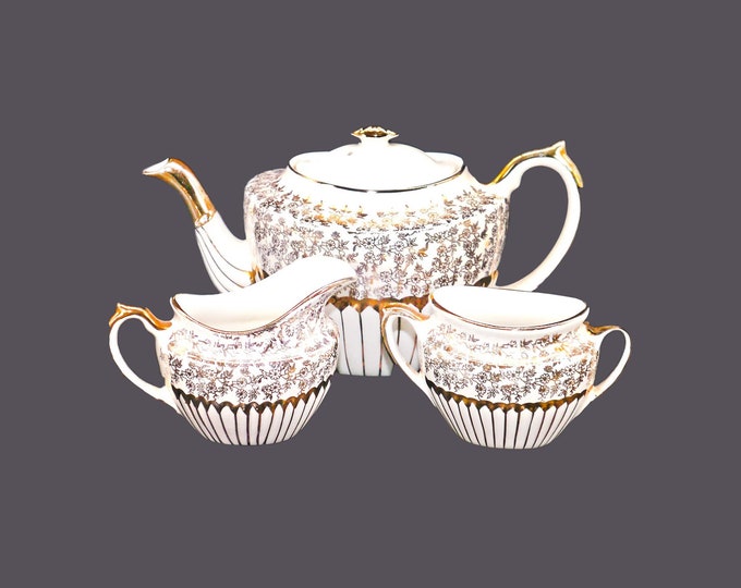 Gibsons England W802 gold floral chintz lusterware creamer, handled sugar bowl and four-cup teapot.