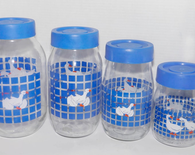 Set of four vintage (1980s) Carlton Glass Marmalade white geese blue checks canisters with removable blue plastic lids. Retro kitchen decor.