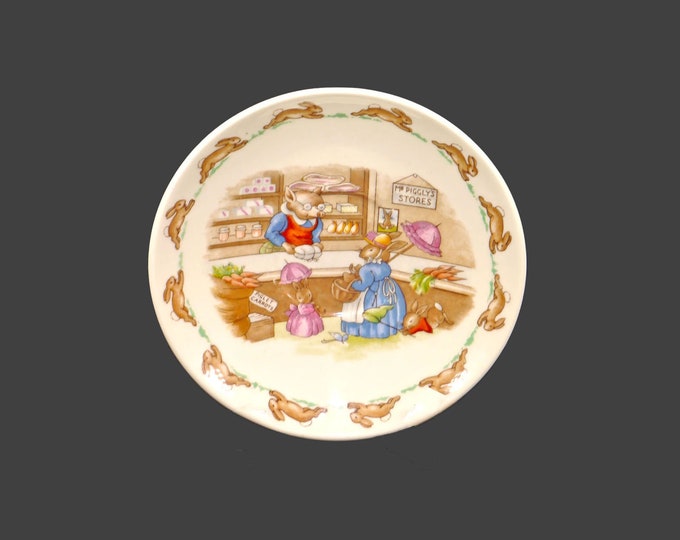 Royal Doulton Bunnykins orphaned saucer only made in England. The bunnies shopping at Mr. Piggly's store.