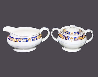 Vintage Grindley creamer and covered sugar bowl set. Yellow flowers on blue.