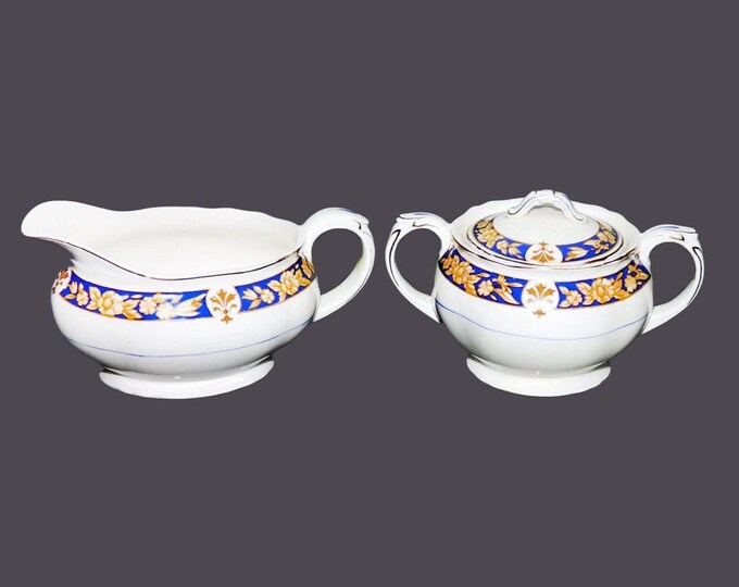Grindley creamer and covered sugar bowl set. Cream Petal ironstone made in England.