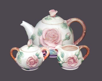 Fitz & Floyd Blushing Rose six-cup majolica teapot, creamer and covered sugar bowl set made in Japan. Flaw (see below).