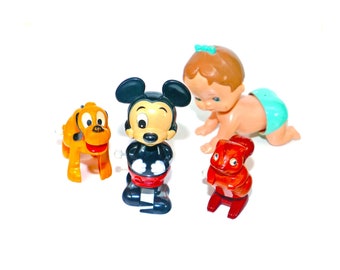 Four Walt Disney | Tomy wind-up toys made in Taiwan circa 1970s.