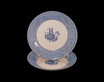 Pair of Royal China Currier & Ives Blue blue-and-white steampunk orphaned saucers made in USA. Flaw (see below).