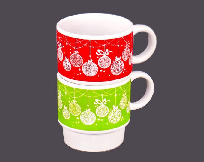 Pair of retro stackable ceramic Christmas coffee or tea mugs. Red and green with white Christmas ornaments.