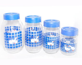 Four Carlton Glass Marmalade white geese blue checks canisters with removable blue plastic lids.