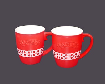 Bailey&#39;s Irish Cream red stoneware mugs with raised Bailey&#39;s wording. Sold as a pair or individually.