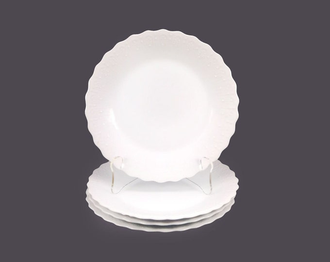 Four Nichinan Paris White salad plates. Chef's favorite all-white with embossed rims made in Japan. Flaw (see below).