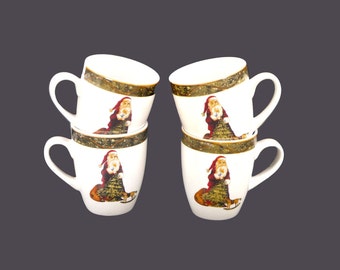 Four Christmas Santa coffee or tea mugs. Santa Claus with sack, rocking horse, tree and green confetti band.