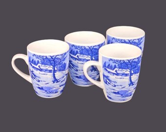 Four Currier & Ives Christmas blue-and-white coffee or tea mugs.