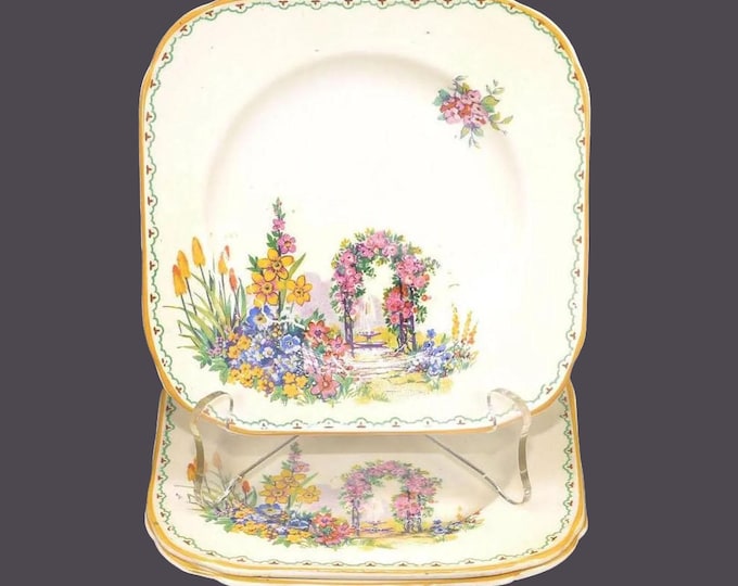 Three HK Tunstall HKI9 square tea, dessert plates. Garden scene of multicolored flowers, fountain, mustard trim. Flaws (see below).