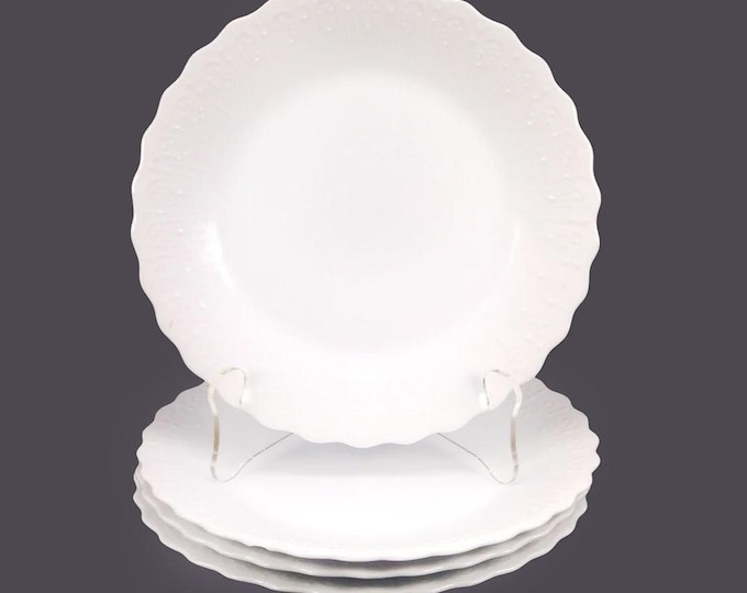 Four Nichinan Paris White salad plates. Chef's favorite all-white with embossed rims made in Japan. Flaw (see below).
