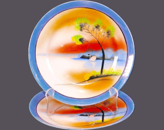Pair of Chikaramachi hand-painted Nippon CHK21 lusterware dessert plates. Swan Lake theme, blue luster rim.