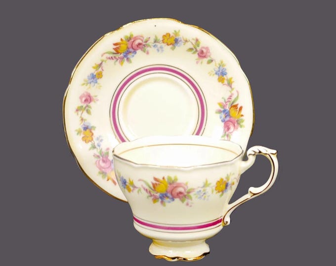 Paragon Z277-4 bone china cup and saucer set made in England. Maroon and gold bands on yellow, floral garland. Minor flaw (see below).