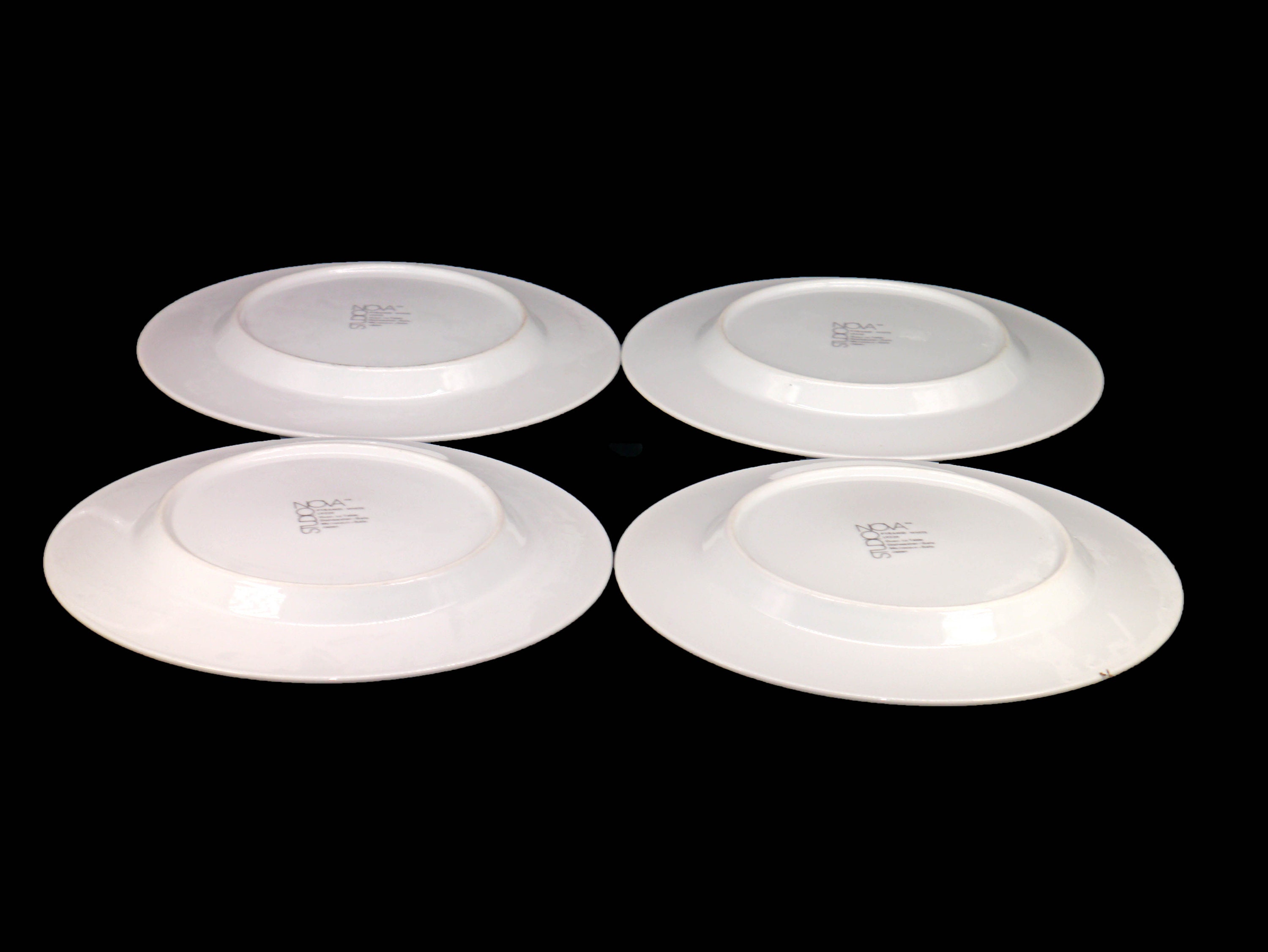 Four Studio Nova Pyramid White large dinner plates made in Japan.