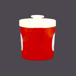 May include: Red plastic container with a white lid and a white label that says "Donor Wallet".