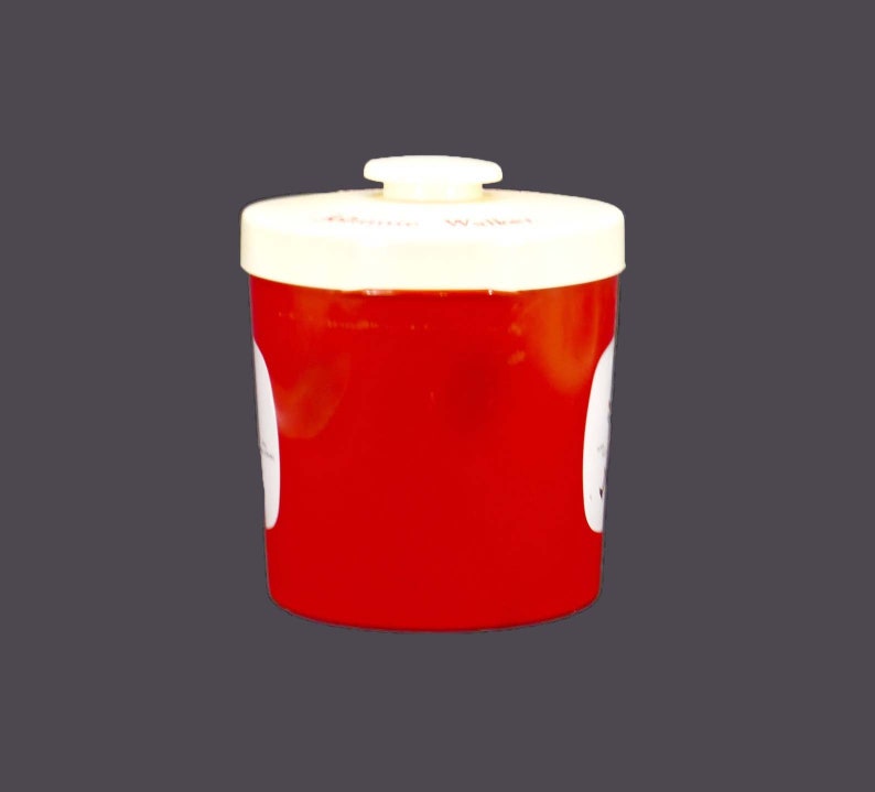 May include: Red plastic container with a white lid and a white label that says "Donor Wallet".