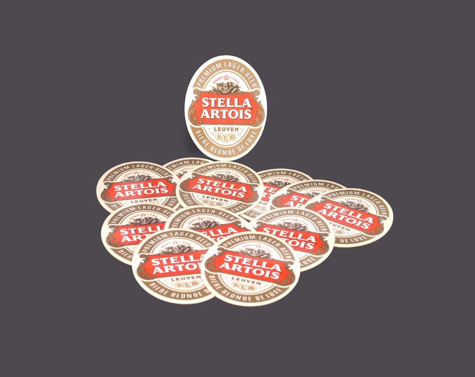 Twelve Stella Artois Biere Blonde Deluxe oval cardboard coasters. Great home bar decor.