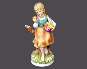 Giftcraft porcelain bisque figurine. Young girl holding fruit. Made in Japanese Taiwan.