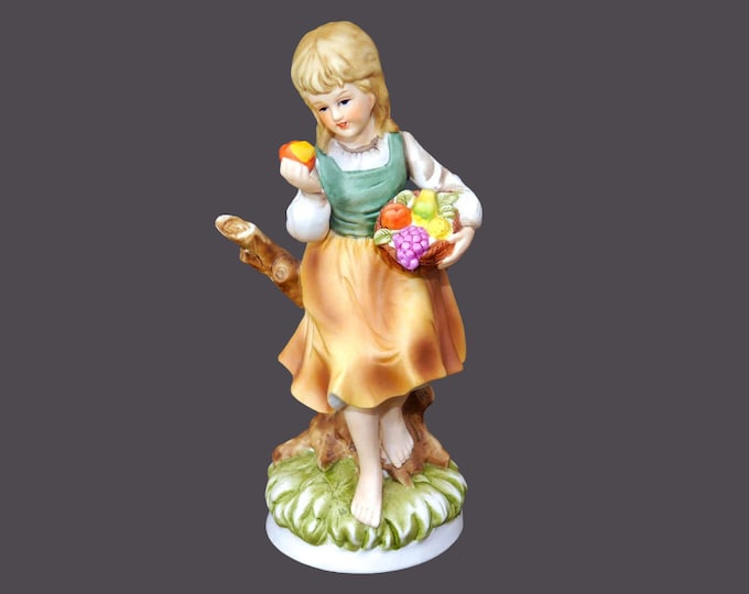 Giftcraft porcelain bisque figurine. Young girl holding fruit. Made in Japanese Taiwan.