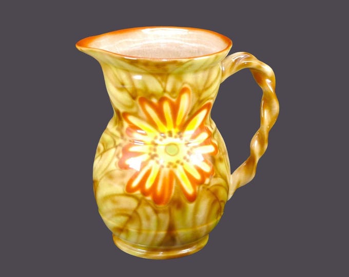 Royal Art Pottery 32-ounce lemonade, kool-aid, iced tea pitcher. Red yellow florals, branch handle. Made in England.