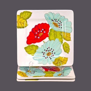 Three Laurie Gates Wildflowers square salad plates.