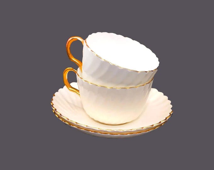 Pair of Minton Clifton Gold bone china cup and saucer sets made in England.