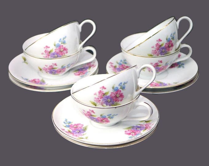 Six Leuco Fine China cup and saucer sets. Pink purple blue florals made in Japan.