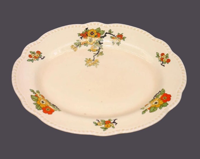 William Wood & Co. W1231 759778 oval platter made in England. Orange red yellow flowers, embossed edge. Flaw (see below).