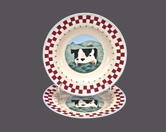 Pair of Tienshan Folk Art stoneware salad plates. Cow in center, red checked rim, blue trim.