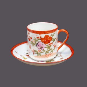 Hand-painted Nippon demitasse cup and saucer set made by Tashiro Shoten. Flowers and butterflies.