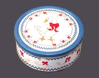 Round cookie tin. White geese, red ribbons, blue checks. American Trends Corp.