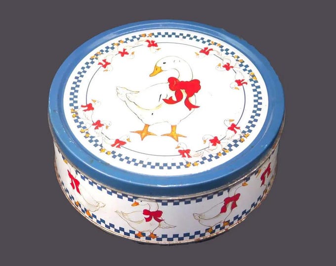 Round cookie tin. White geese, red ribbons, blue checks. American Trends Corp.