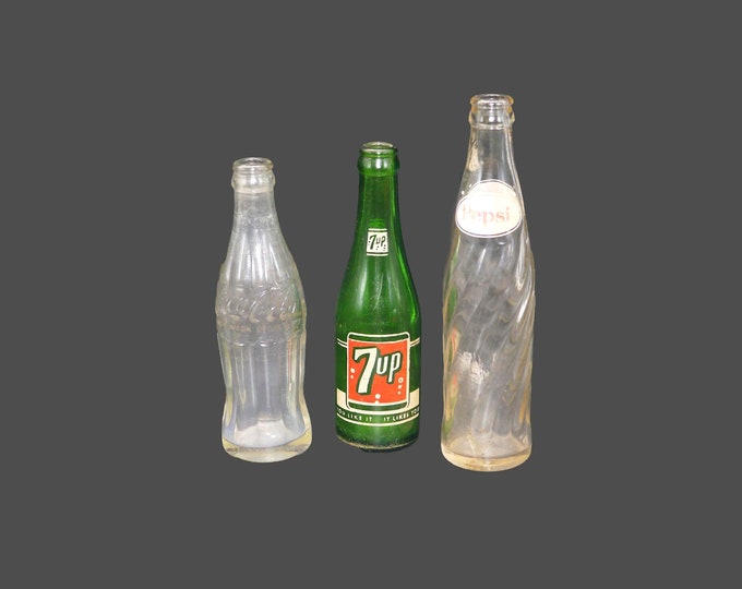 Three mid-century glass soda pop bottles Pepsi, 7Up, Coke. No caps. Great home bar decor.