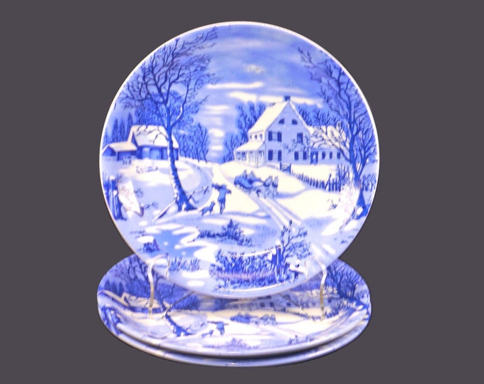 Three Currier & Ives blue-and-white Christmas salad plates.