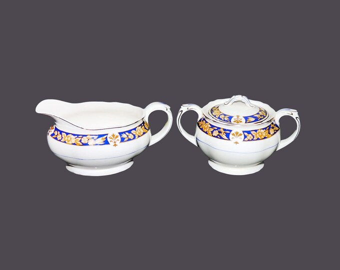 Grindley creamer and covered sugar bowl set. Cream Petal ironstone made in England.