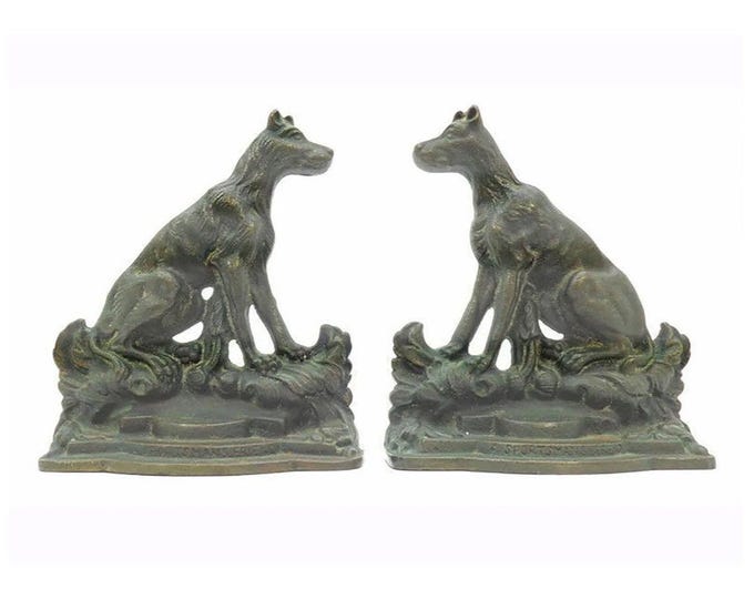 Pair of Antique cast iron dog book ends A Sportsman's Friend by artist Emanuel Hahn. Bronze patina, felt covering to bases.