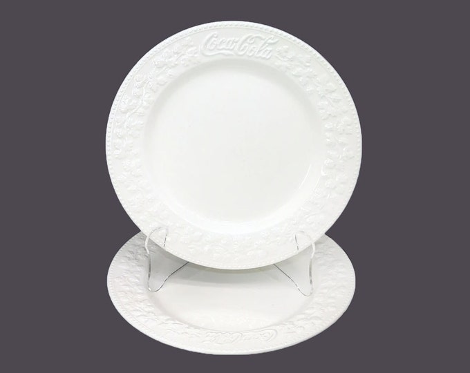 Pair of Coca-Cola Chef's favorite all-white dinner plates made in Italy by Quadrifoglio. Embossed Coca-Cola logo and leaves.