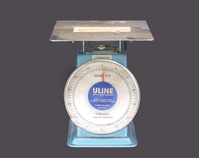 Uline 870 metal parcel weighing scale with calibration knob made in Taiwan. Handles up to 70 lbs.