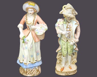Pair of mid-century porcelain bisque figurines. Man and woman in period dress. Made in Occupied Japan.