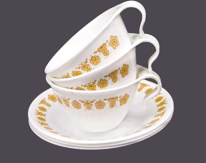 Three retro Corelle Corning Butterfly Gold hangable cup and saucer sets. Vintage Corningware made in USA.
