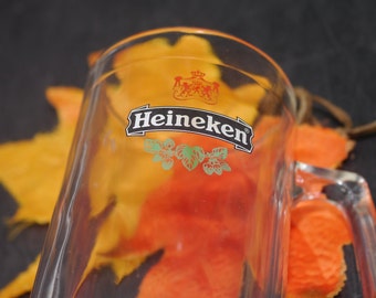 Heineken half-pint handled stein. Etched-glass branding, weighted base.